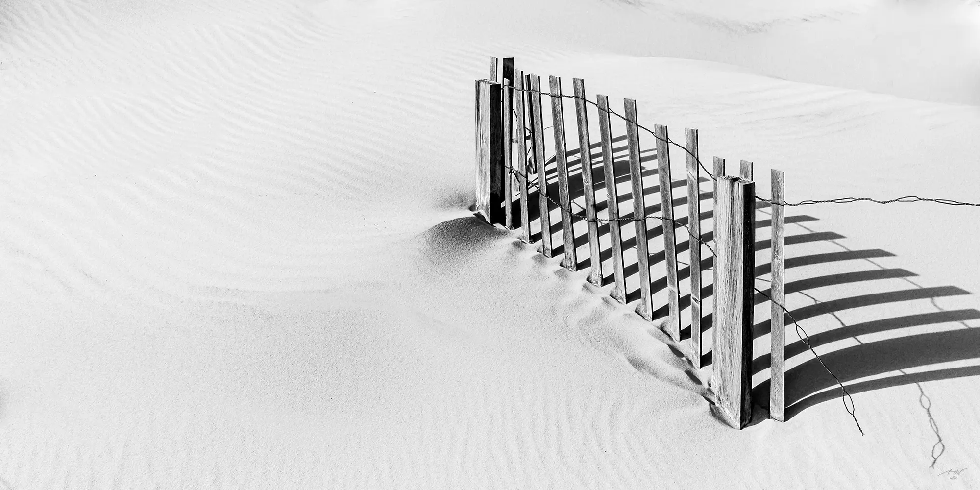 Wood fence in sand dune