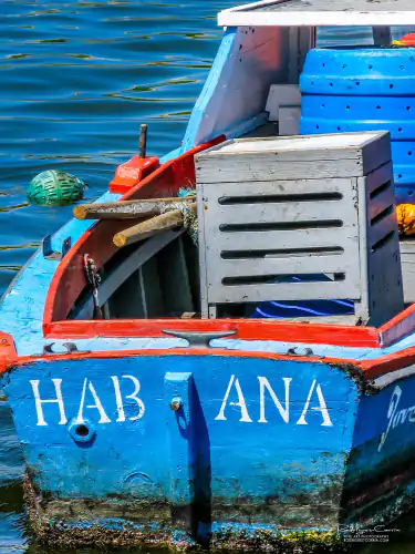 A colorful cuban fishing boat on the malecon.
